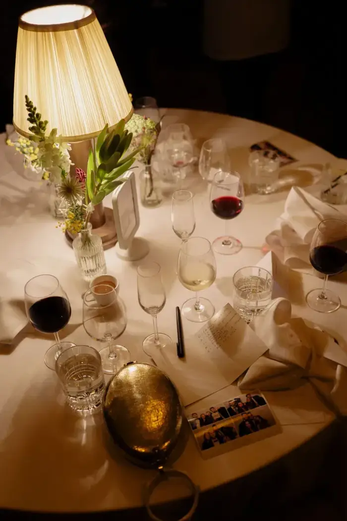 Candlelit reception table with a bud vase of white and green flowers